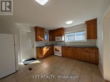 Toronto (West Hill) apartment for rent - A kitchen with wooden cabinets and a white refrigerator.