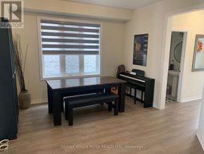 Clarington (Newcastle) apartment for rent - A black piano is in a room with a table and bench.