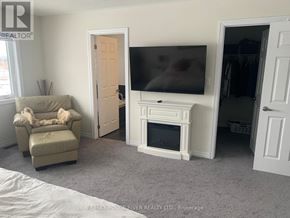 Clarington (Newcastle) apartment for rent - A living room with a couch, chair, and television.
