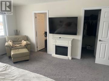 Clarington (Newcastle) apartment for rent - A living room with a couch, chair, and television.