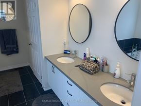 Clarington (Newcastle) apartment for rent - A bathroom with a white vanity and two sinks.