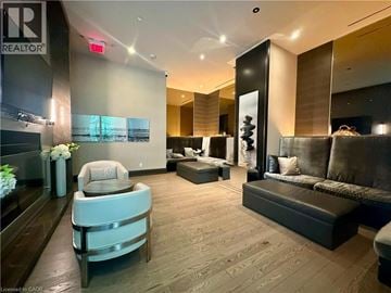 Etobicoke condo for rent - A well-lit, modern living room with a grey sofa and a wooden floor.