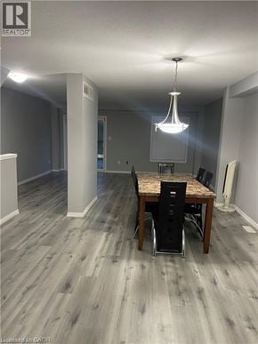 Kitchener townhouse for rent - A dining room with a wooden table and chairs.