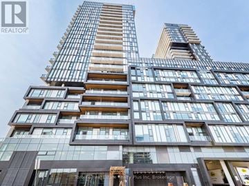 Toronto (Dovercourt-Wallace Emerson-Junction) condo for rent - A tall building with many windows and balconies, with a sign that reads "REALTOR®".
