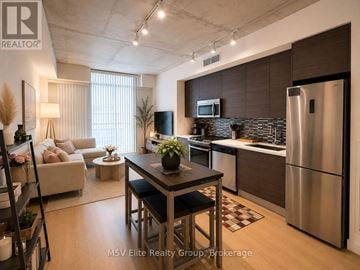 Toronto (Waterfront Communities) condo for rent - A modern kitchen with a dining table and chairs in the middle of the room.