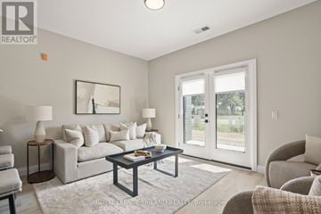 Lucan Biddulph (Lucan) apartment for rent - A living room with a grey couch, a coffee table, and a painting on the wall.