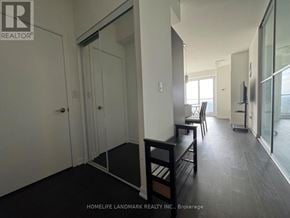 Toronto (Lansing-Westgate) condo for rent - A room with a glass door and a black bench.
