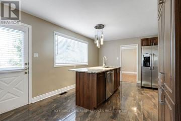 Ottawa apartment for rent - A kitchen with a wooden island and a refrigerator in the background.