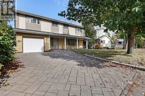Ottawa apartment for rent - A residential building with a driveway in front.