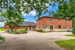 Ancaster apartment for rent - A red brick house with a driveway in front.