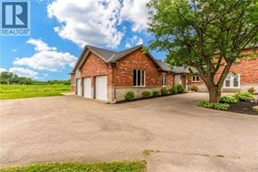 Ancaster apartment for rent - A large brick house with a white garage door is for sale.