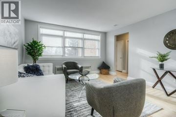 Kitchener apartment for rent - A living room with a grey sofa and a glass coffee table.