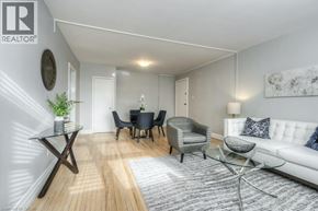 Kitchener apartment for rent - A living room with a white couch, a glass coffee table, and a white rug.