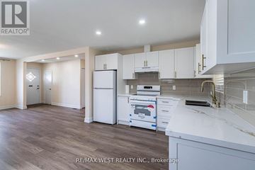 Toronto (Yorkdale-Glen Park) apartment for rent - A kitchen with white cabinets and a white fridge.