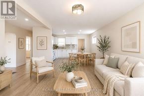 Toronto (Yorkdale-Glen Park) apartment for rent - A well-lit living room with a couch, chairs, and a coffee table.