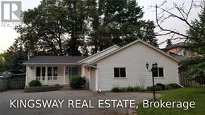 Oakville (Fd Ford) apartment for rent - A white house with a porch and a sign that says Kingsway Real Estate Brokerage.