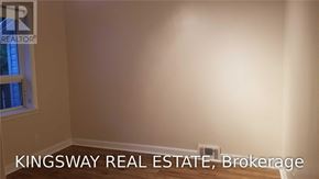 Oakville (Fd Ford) apartment for rent - A Kingsway Real Estate Brokerage logo is displayed on a wall.