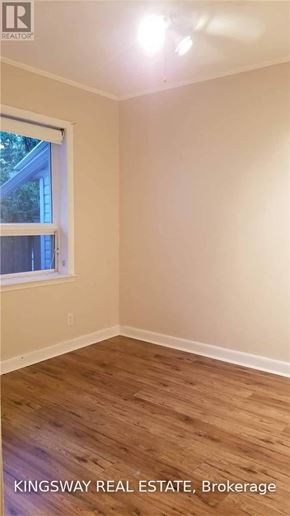 Oakville (Fd Ford) apartment for rent - A room with a window and wooden flooring.