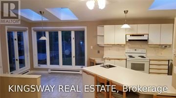 Oakville (Fd Ford) apartment for rent - A kitchen with a skylight and a stove top oven.