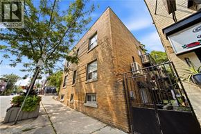 Toronto apartment for rent - A brick building with a balcony and a sign that says REALTOR.