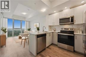 Kitchener condo for rent - A modern kitchen with stainless steel appliances and wooden floors.