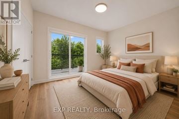 Ottawa townhouse for rent - A bedroom with a large bed and a view of trees through the window.