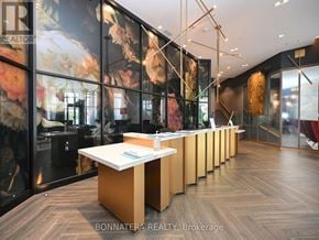 Oakville (Go Glenorchy) condo for rent - A real estate office with a long counter and a sign that says "REALTOR".