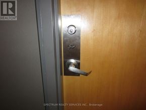 Toronto (Long Branch) condo for rent - A door with a silver handle and a number 512 on it.