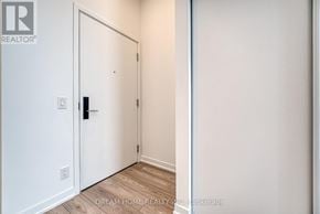 Toronto (South Parkdale) condo for rent - A white door with a black handle is in a room with white walls.