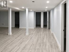Brampton (Credit Valley) apartment for rent - A long hallway with white walls and wood flooring.