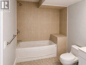 Brampton (Credit Valley) apartment for rent - A bathroom with a white tub and tiled walls.