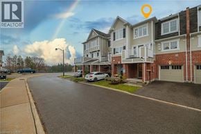 Cambridge townhouse for rent - A street view of a residential area with apartment buildings and cars parked on the side of the road.
