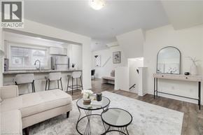 Cambridge townhouse for rent - A living room with a white couch and a glass table.