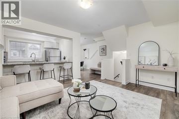Cambridge townhouse for rent - A living room with a white couch and a glass table.