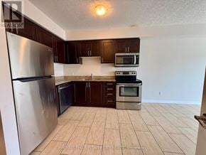 Hamilton (Meadowlands) condo for rent - A kitchen with a refrigerator, microwave, oven and cabinets.