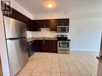 Hamilton (Meadowlands) condo for rent - A kitchen with a refrigerator, microwave, oven and cabinets.