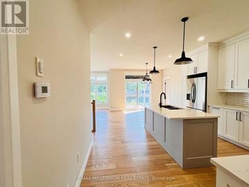 Southwold (Talbotville) apartment for rent - A modern kitchen with white cabinets and a central island.