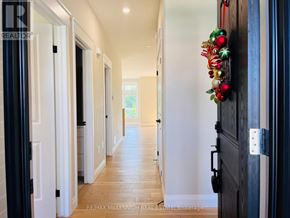 Southwold (Talbotville) apartment for rent - A hallway with a garland of Christmas ornaments on the wall.