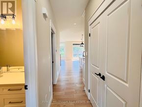 Southwold (Talbotville) apartment for rent - A hallway with white doors and a light on the wall.