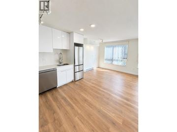 Coquitlam apartment for rent - A kitchen with white cabinets and a wooden floor.