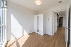 Coquitlam apartment for rent - A room with a wooden floor and white walls.