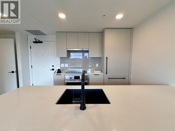 Vancouver apartment for rent - A modern kitchen with a sink and cabinets.