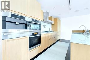 Vancouver apartment for rent - A modern kitchen with wooden cabinets and stainless steel appliances.