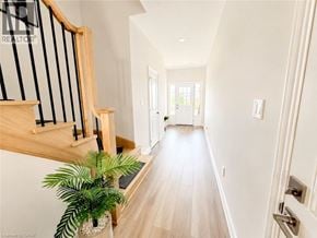 Thorold townhouse for rent - A long hallway with a plant on the left side.