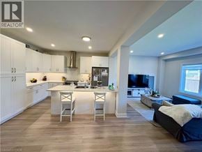 Thorold townhouse for rent - A well-lit, modern kitchen with white cabinets and a large island.