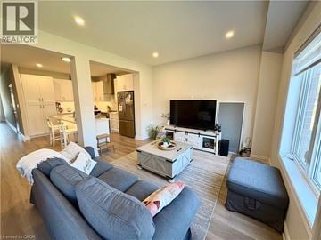 Thorold townhouse for rent - A living room with a grey couch and a television.