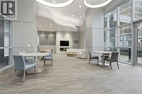 Burlington condo for rent - A modern dining room with a TV and a glass wall.