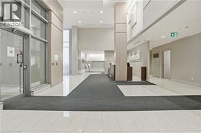 Burlington condo for rent - A hallway with a carpeted entrance and a glass door with a sign that says REALTOR.