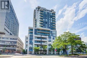 Toronto (University) condo for rent - A tall building with many windows is in the background.