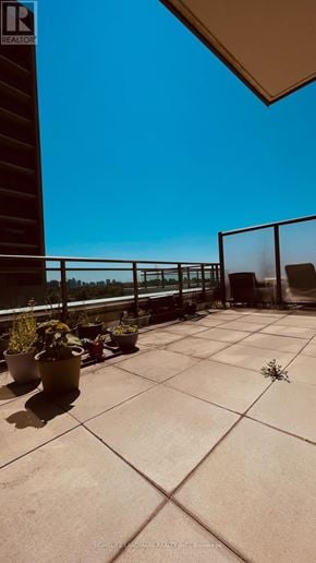 Toronto (University) condo for rent - A patio with a table and chairs overlooking a railing.